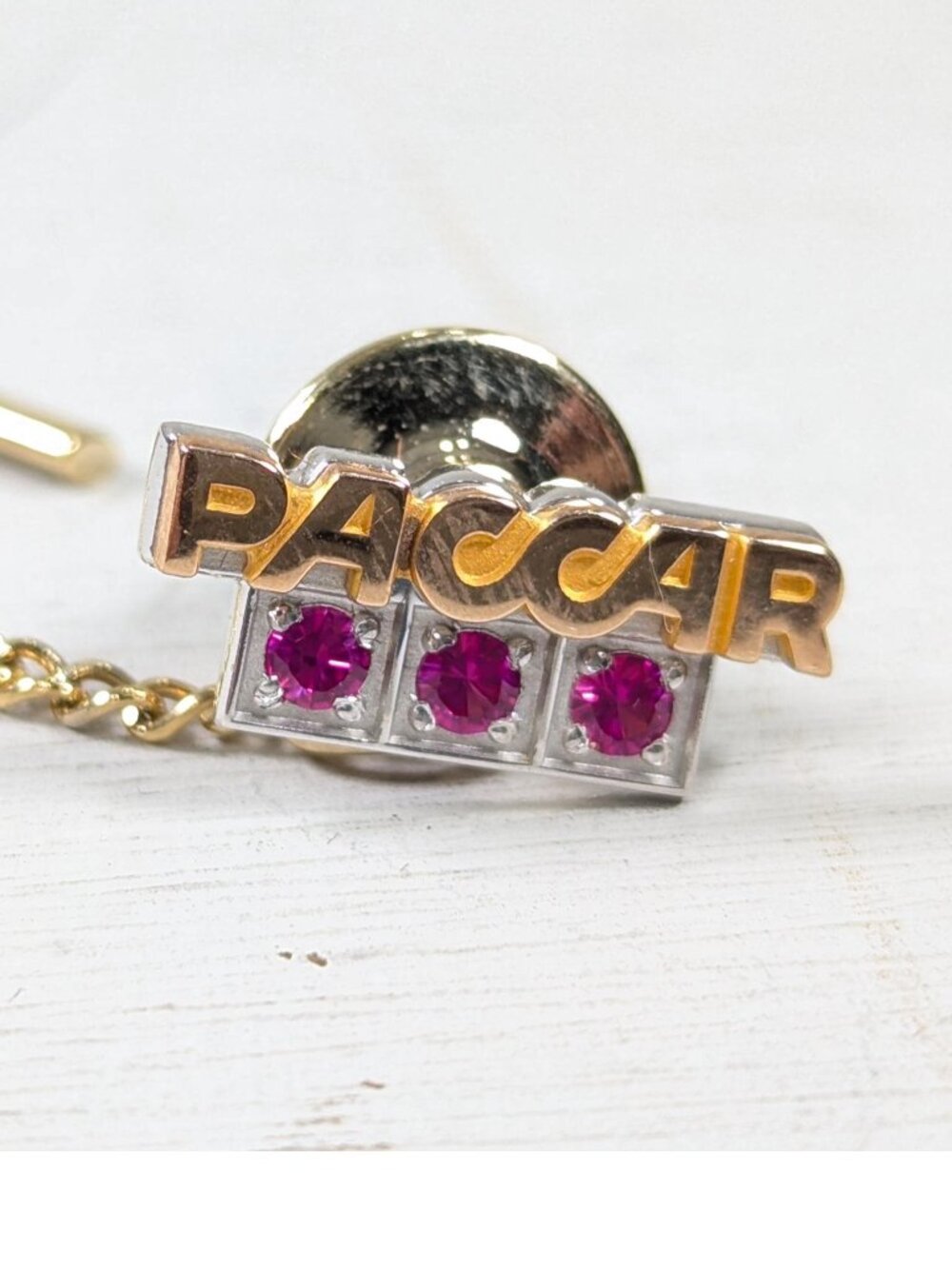 Vintage 10K gold PACCAR logo tie pin, 3 red / pink stones trucker tie tack